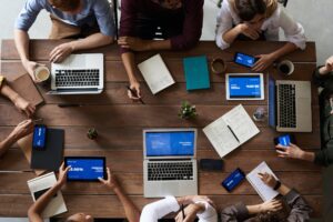 One of the responsibilities of a fractional COO, leadership is gathered around a table discussing how to fine tune their processes.