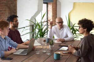 A group of people are gathered for a meeting to both introduce and explain what is a fractional COO.